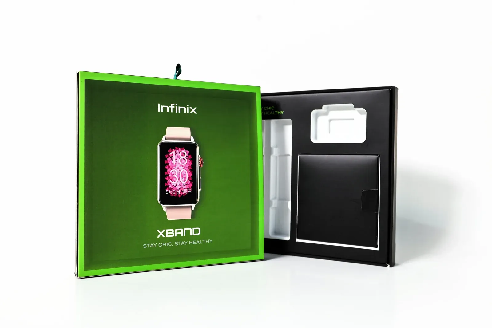 Infinix XBAND smartwatch box opened to show a white tray insert in a black base